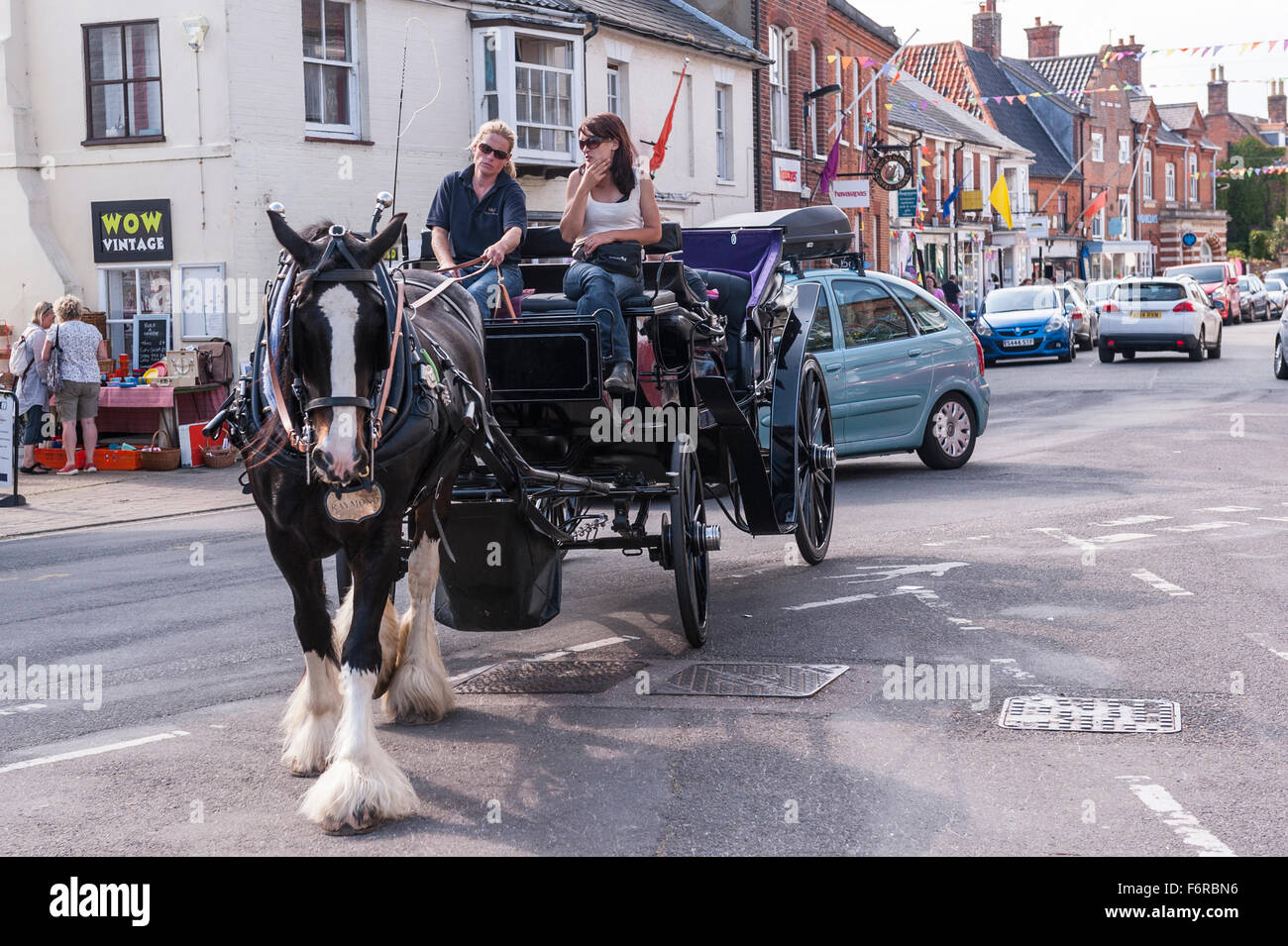 A horse and carriage ride in the High Street  in Southwold , Suffolk , England , Britain , Uk Stock Photo