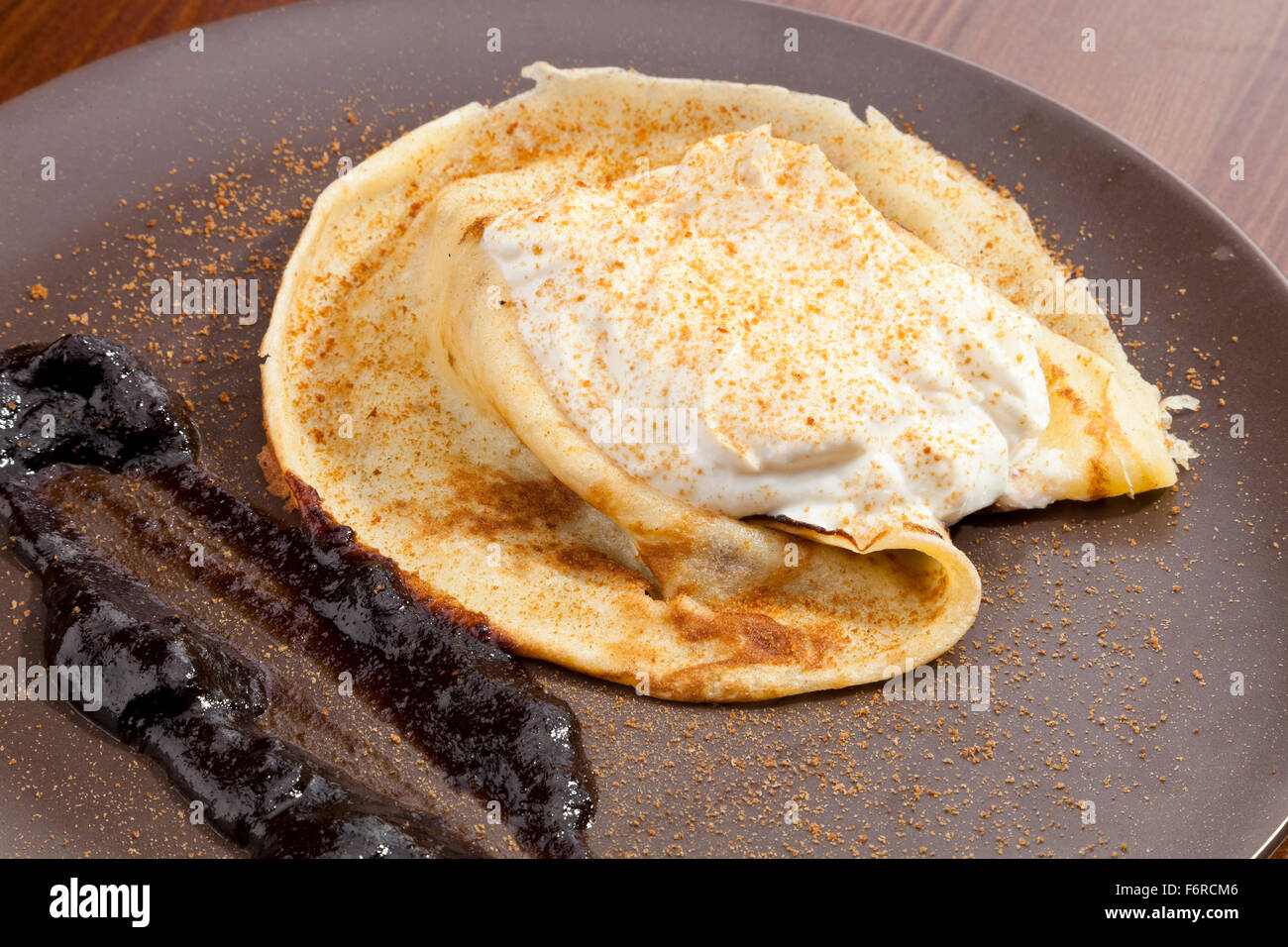 Crepe pancake with whipped cram and gingerbread powder Stock Photo
