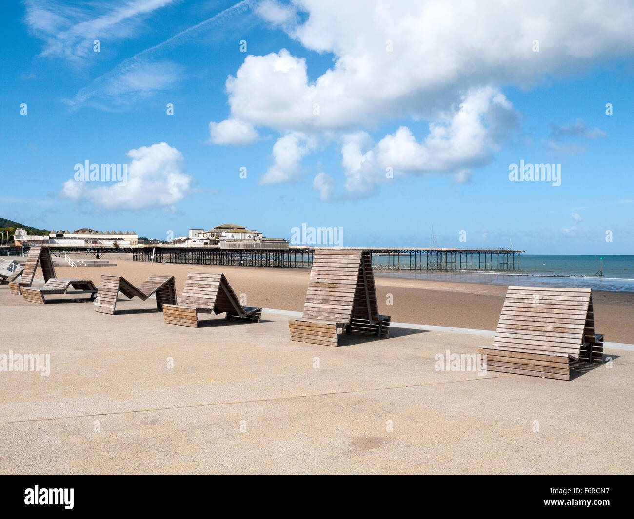 Seating on beach in Colwyn Bay with Victoria pier in distance Wales UK ...