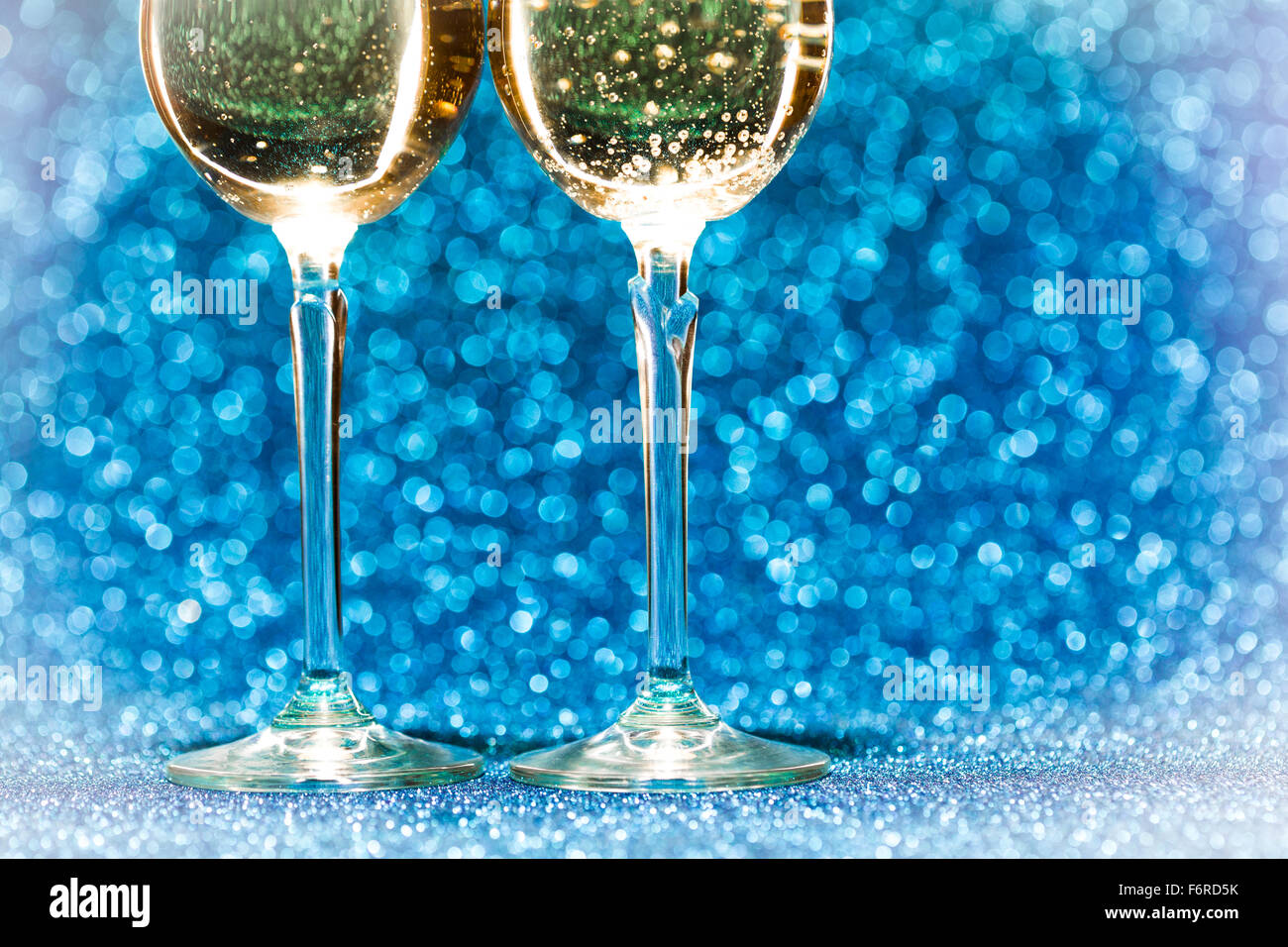 Two glasses of champagne with lights in the background Stock Photo