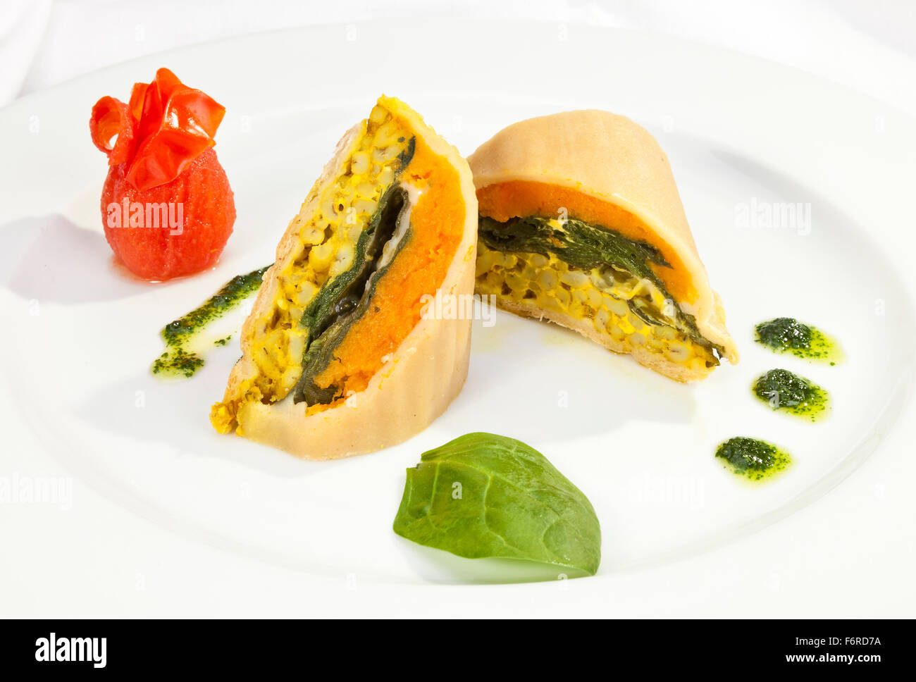 Vegetarian roulade with spinach, carrot and curry rice Stock Photo
