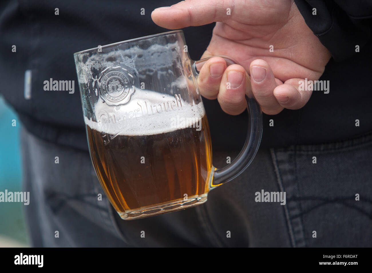 Man holding back Czech beer glass Pilsner Urquell beer, Czech Republic Stock Photo
