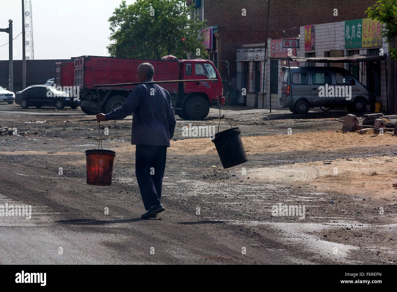 A Old Man by the Dirty Road, Yellow River Industry Area, China. Stock Photo