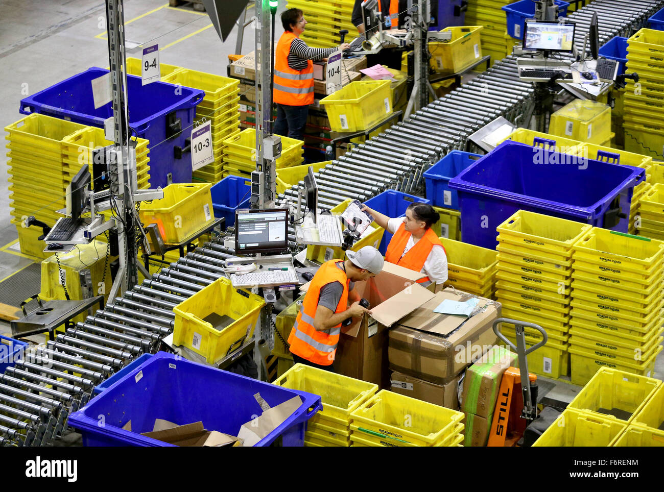 Employees at the Amazon logistics center prepare packages for delivery ...