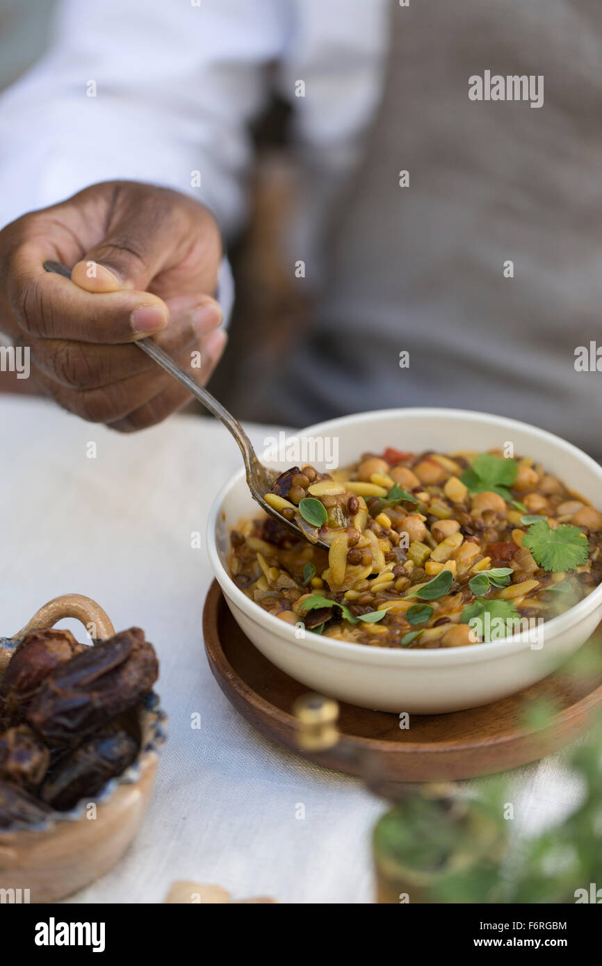 A man is about to eat a bowl of hearthy harira. Stock Photo