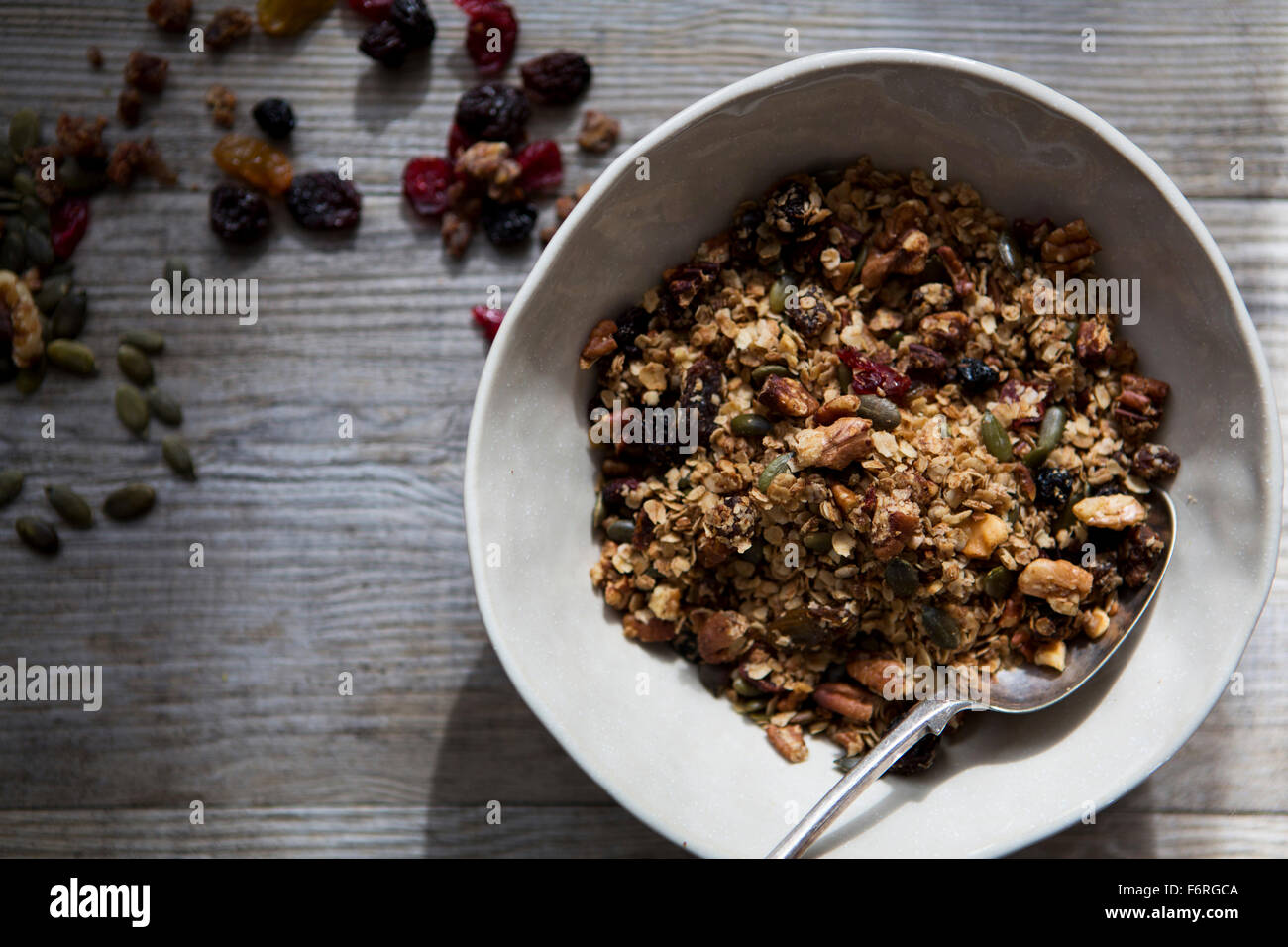 Bowl of Homemade Granola with Nuts, Seeds, Raisins & Cranberries Stock Photo