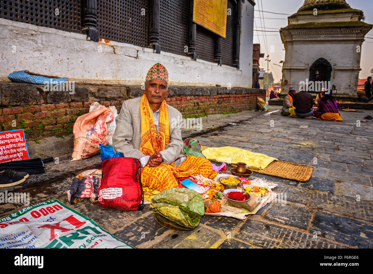 Nepalese man selling religious tools in  ancient Pashupatinath Temple complex Stock Photo