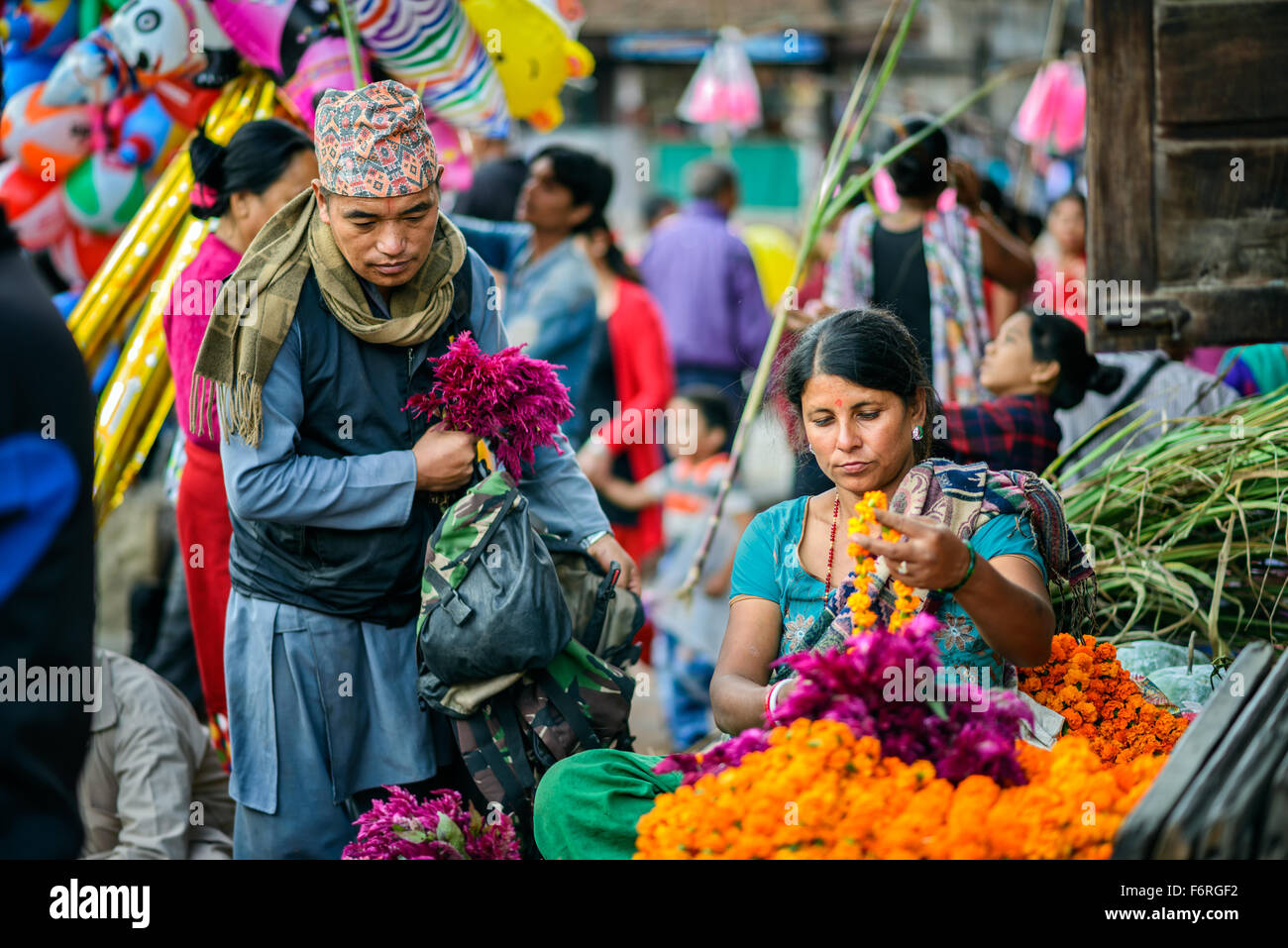 Nepalese woman selling flowers at a local market in Kathmandu Stock Photo