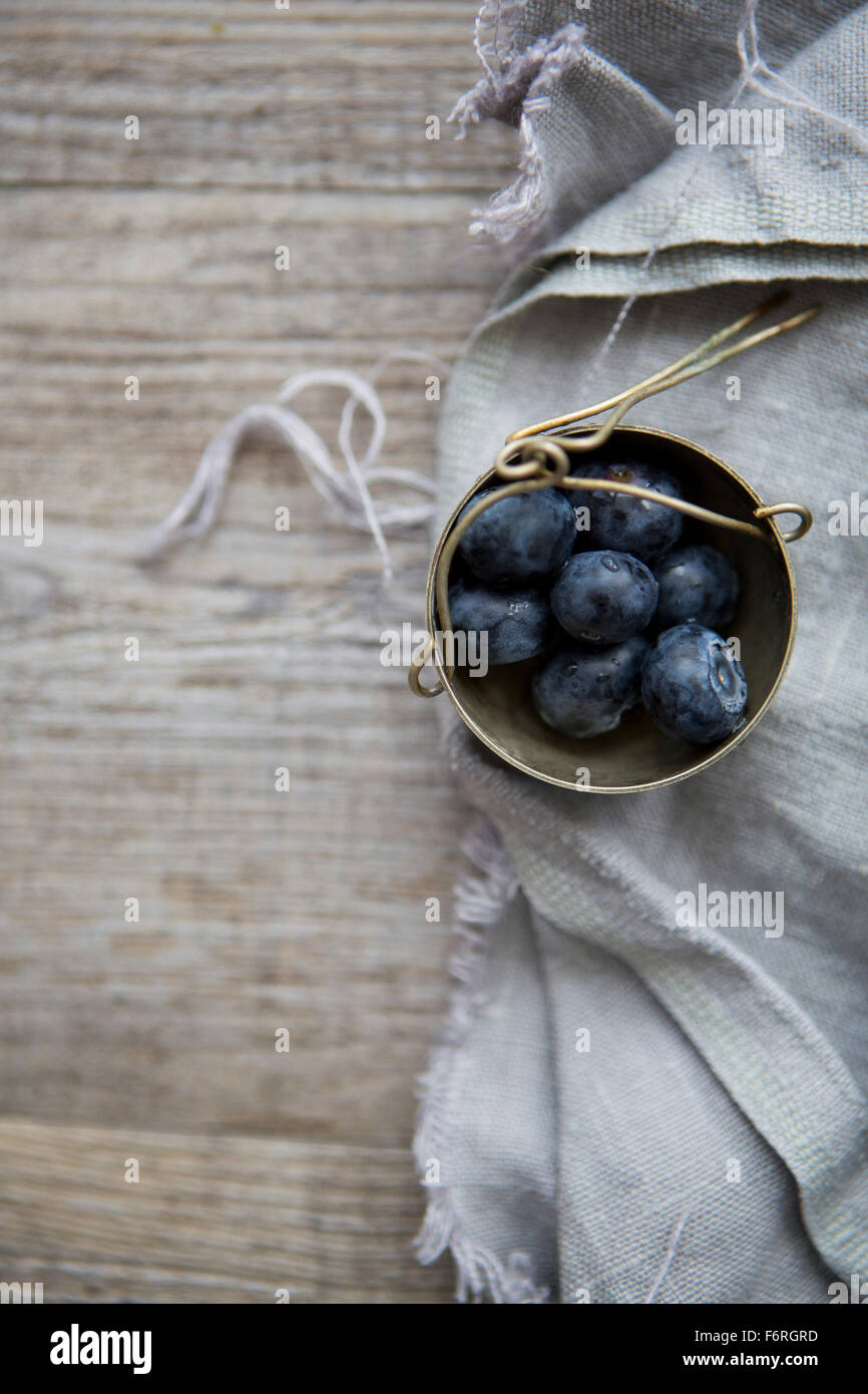 Pot of Blueberries on Linen Cloth & Table Stock Photo