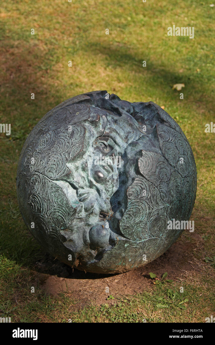 Bronze cast sphere with a split running down the centre revealing faces