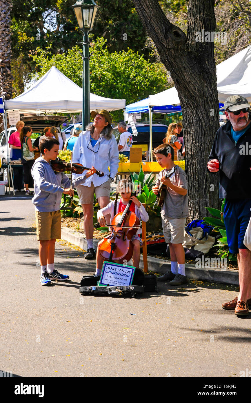 Child musicians entertain the shoppers at the weekly Saturday Farmers Market in Santa Barbara, California Stock Photo