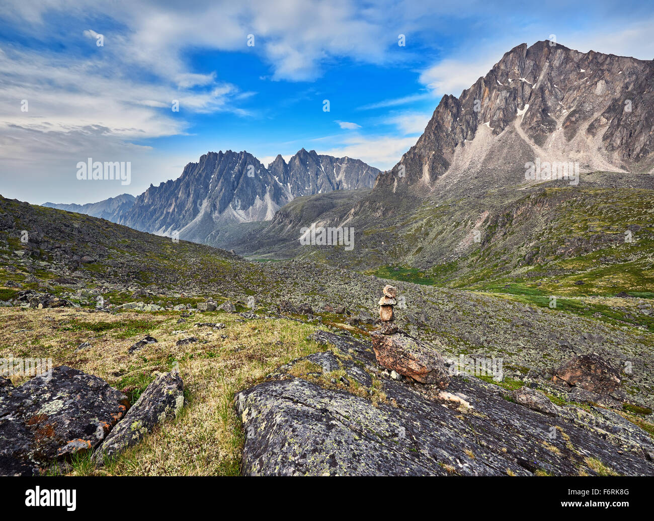 Pyramid of stones - a pointer to the path in the mountain tundra. Eastern Sayan.The Republic of Buryatia Stock Photo