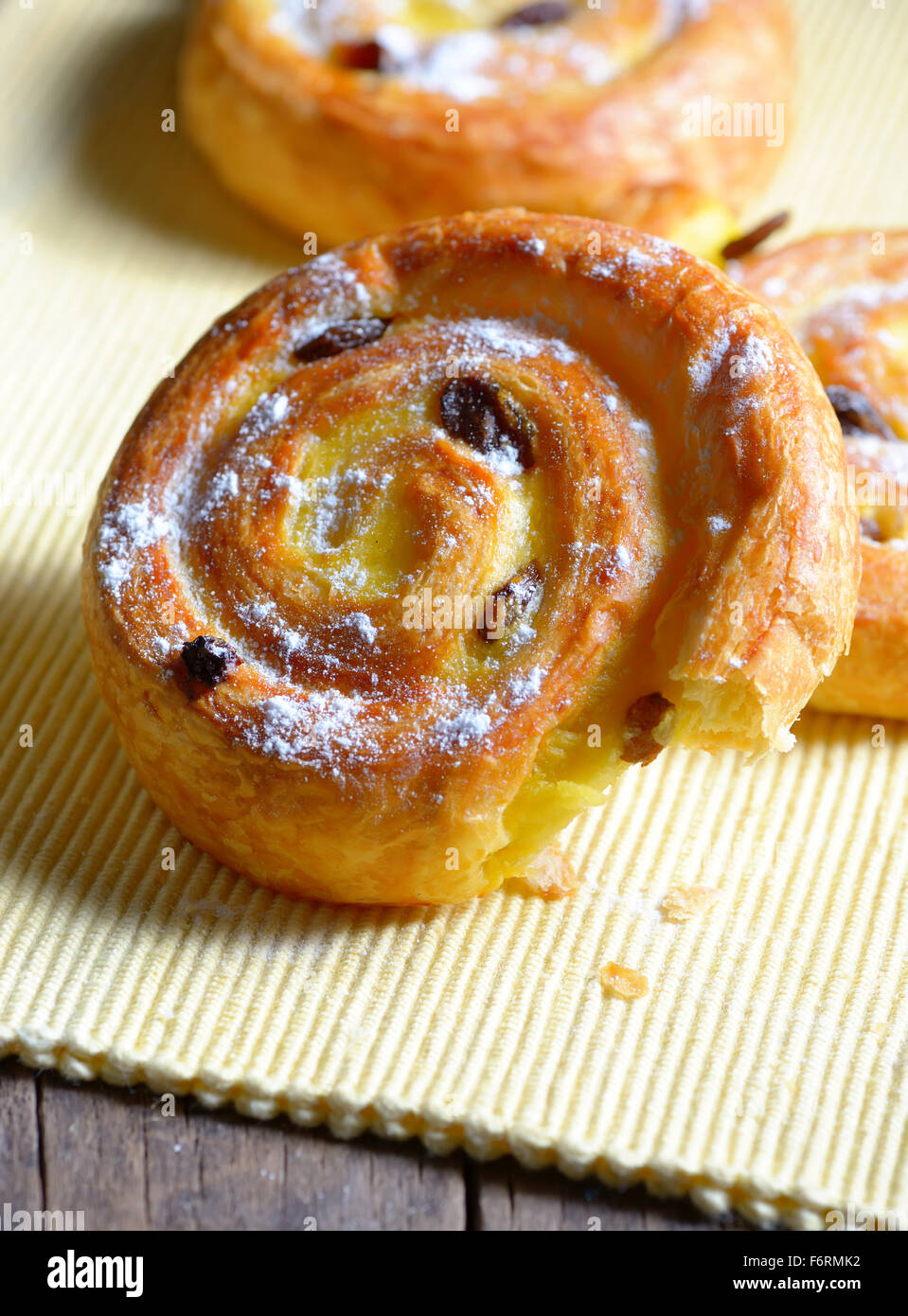 Pastry swirls with raisins on old wood Stock Photo