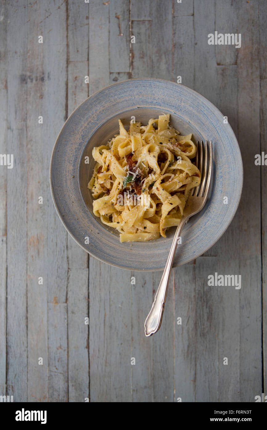 Bowl of Pasta with Caramalised Onions & Parmesan Stock Photo