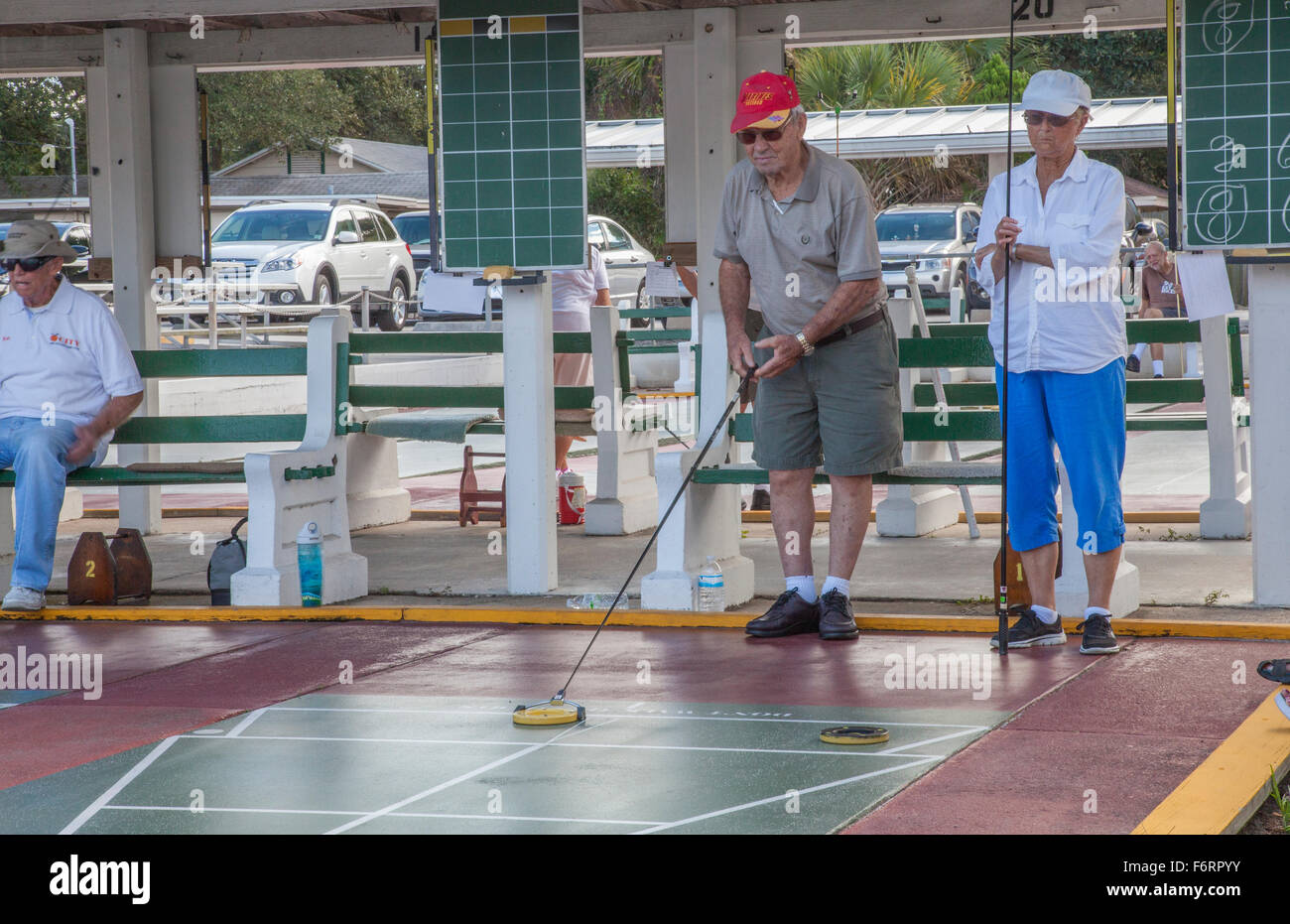 Senior citizens playing competitive shuffleboard game in Flager Ave in