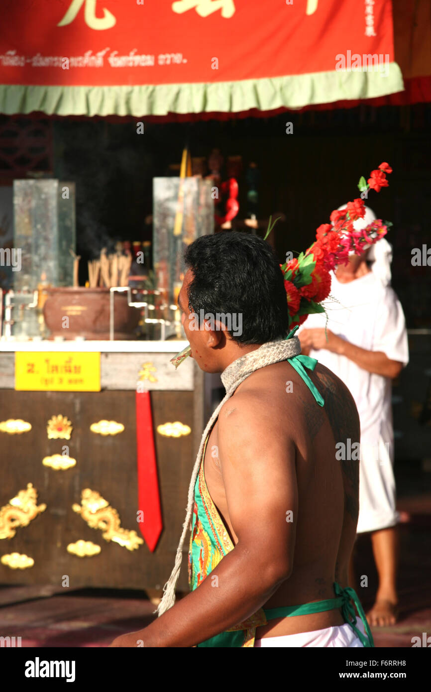 Thailand Phuket Festivals A Mah Jong going through the ritual of face piercing  Adrian Baker Stock Photo