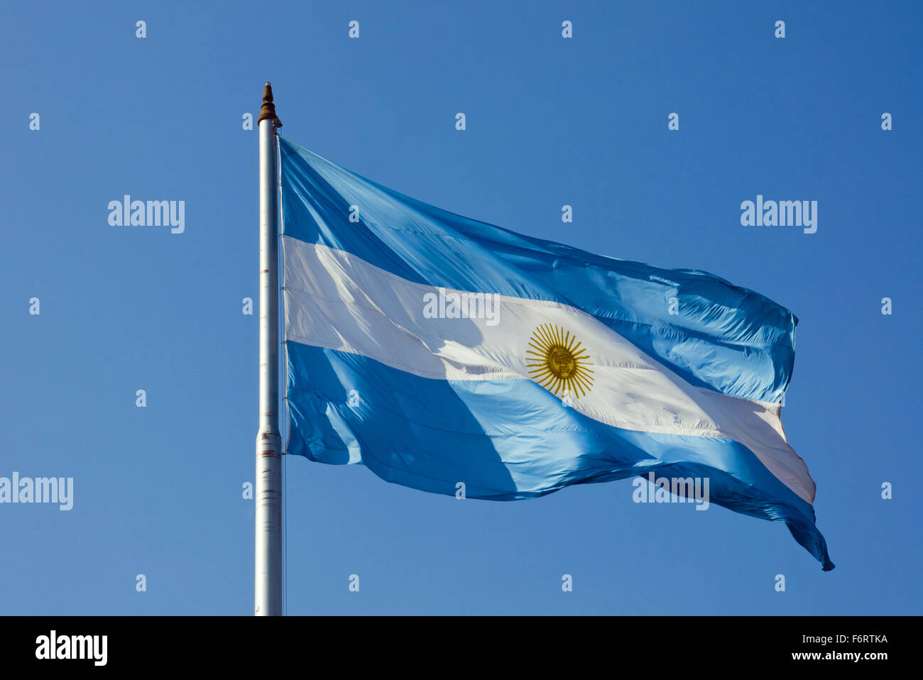 An Argentinean flag in front of a blue sky Stock Photo
