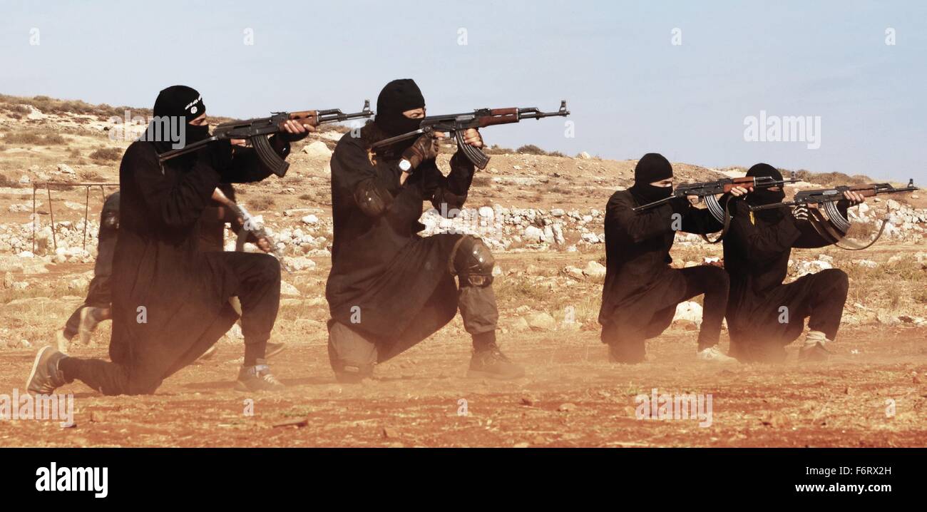 Islamic State of Iraq and the Levant propaganda photo showing masked militants firing AK-47 automatic rifles. Stock Photo