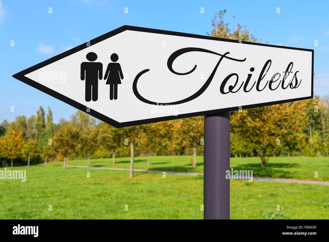 Toilet sign. Signpost pointing to the direction of public toilets. Stock Photo
