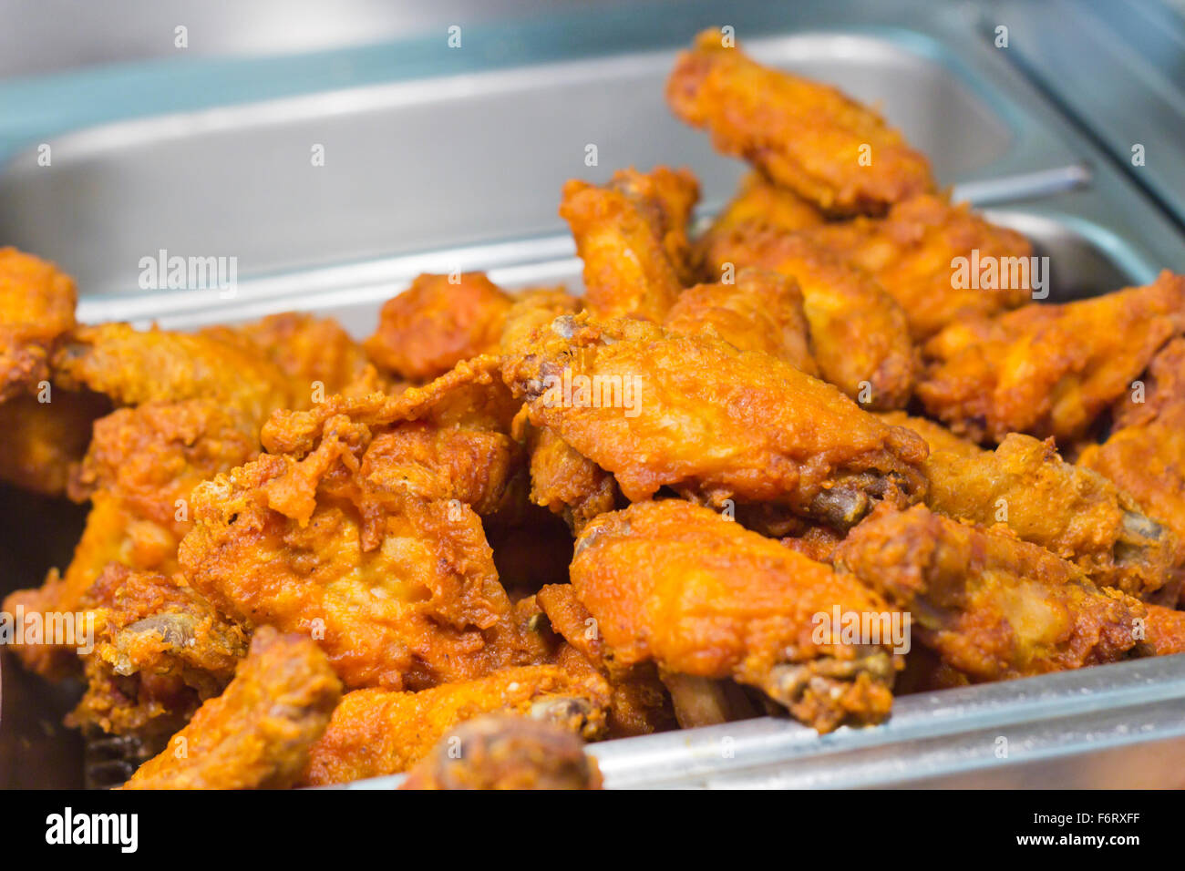 Crispy fried chicken legs and wings in restaurant tray Stock Photo - Alamy