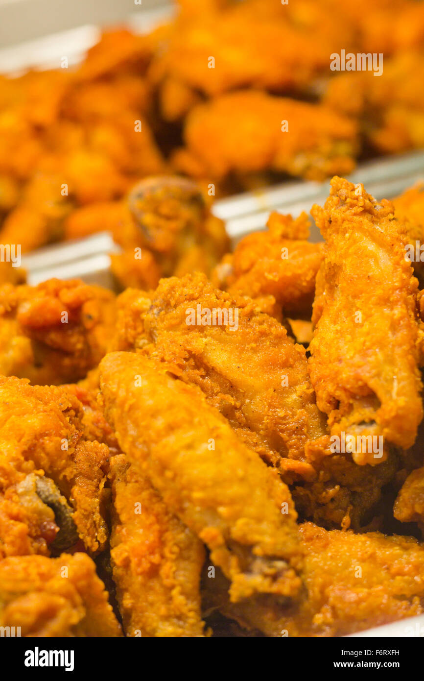 Crispy fried chicken legs and wings in restaurant tray Stock Photo - Alamy