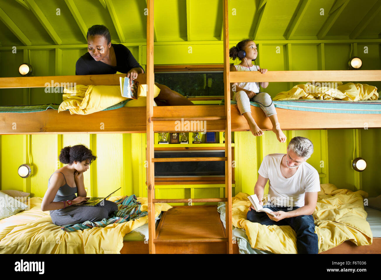 Family relaxing in bunk beds at camp Stock Photo