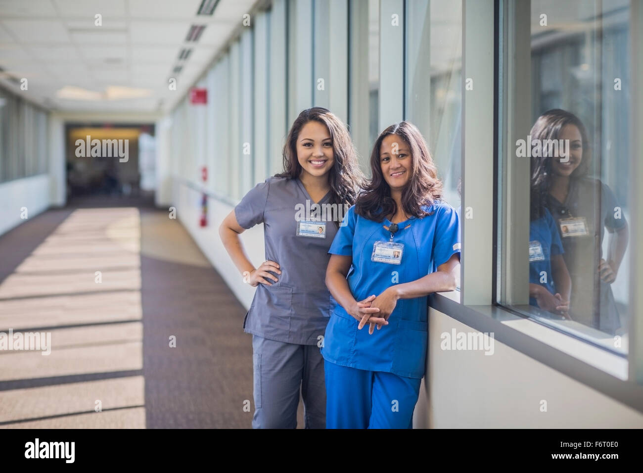 Nurses smiling in hospital hallway Stock Photo