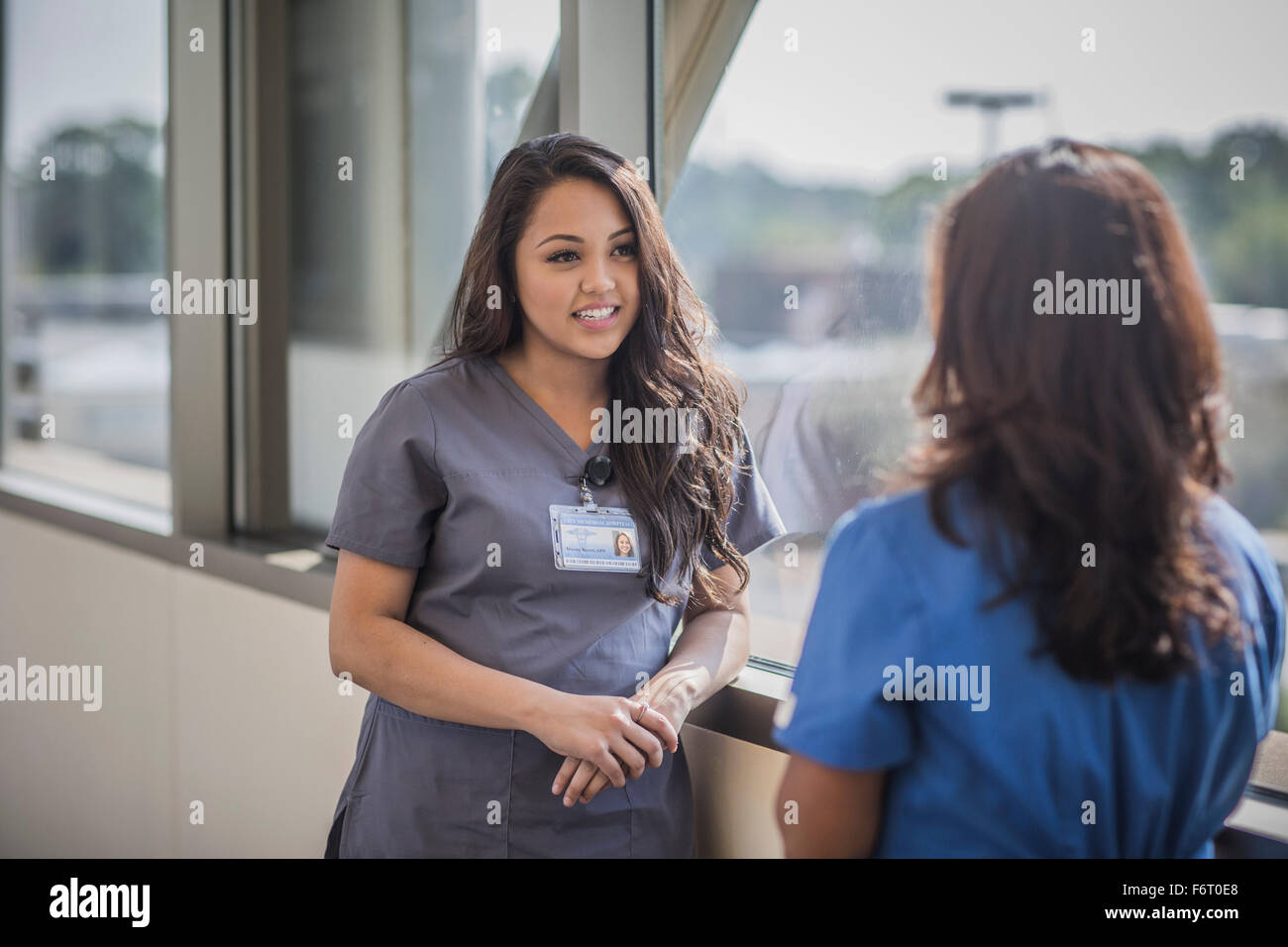 Nurses talking in hospital hallway Stock Photo