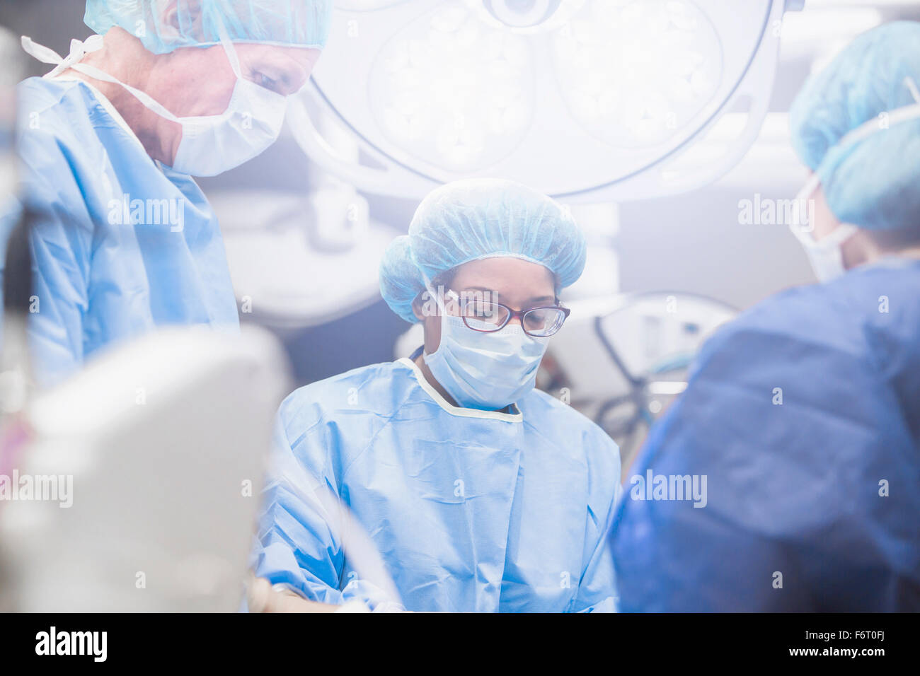 Surgeons working in operating room Stock Photo