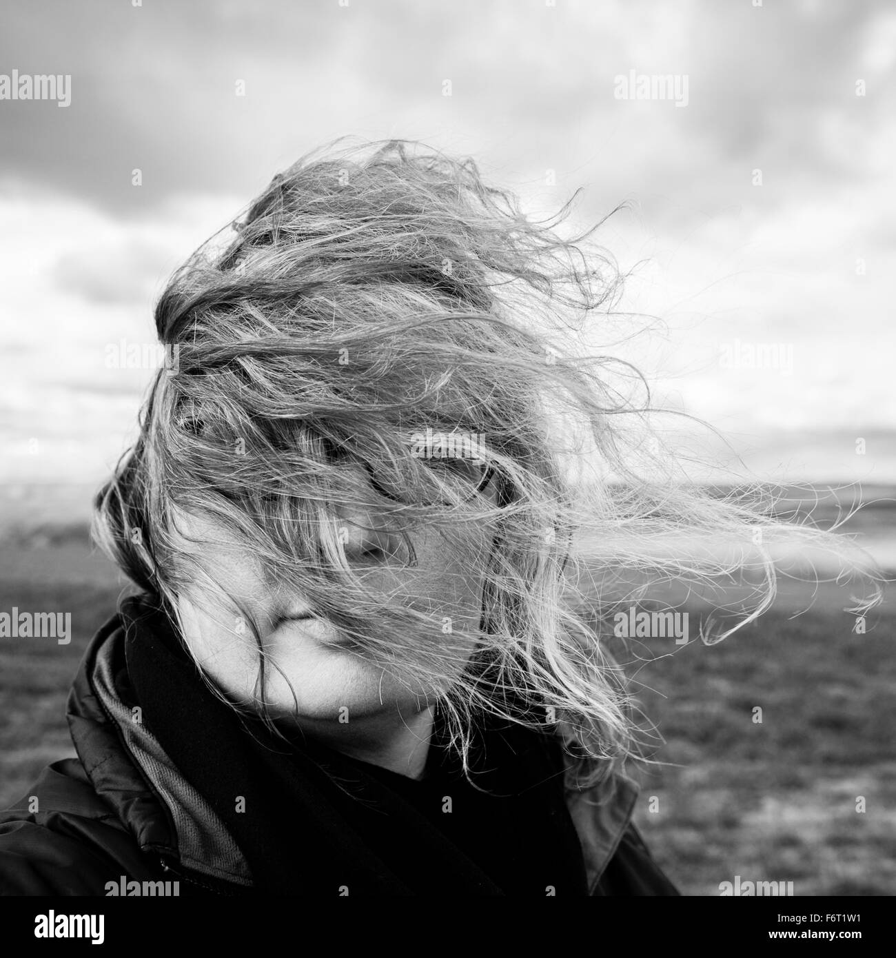 Caucasian woman with hair blowing in wind Stock Photo