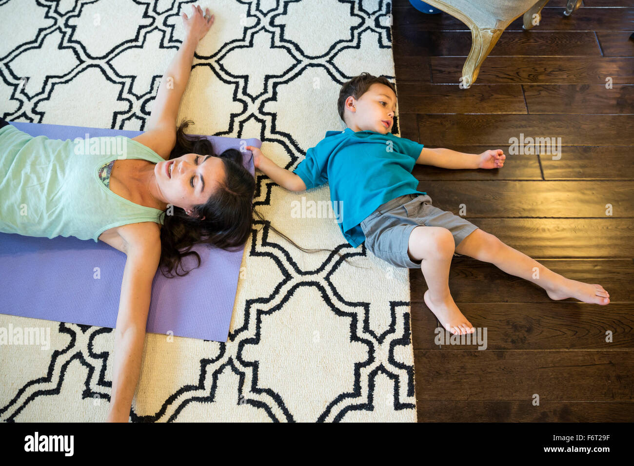 Mother and son laying on floor Stock Photo