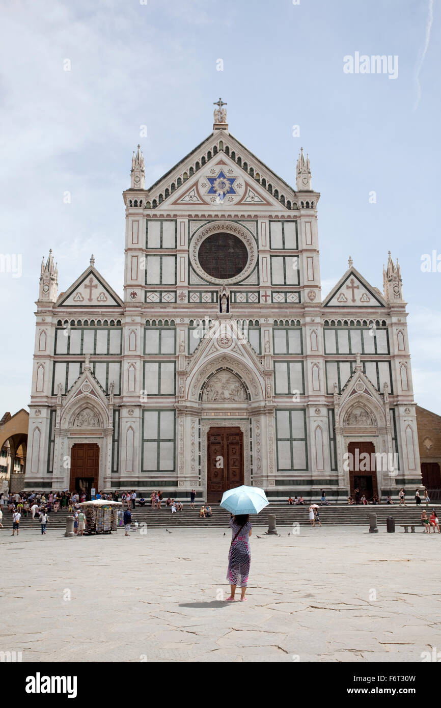 A tourist in front of Basilica Santa Croce, Florence, Italy. Stock Photo