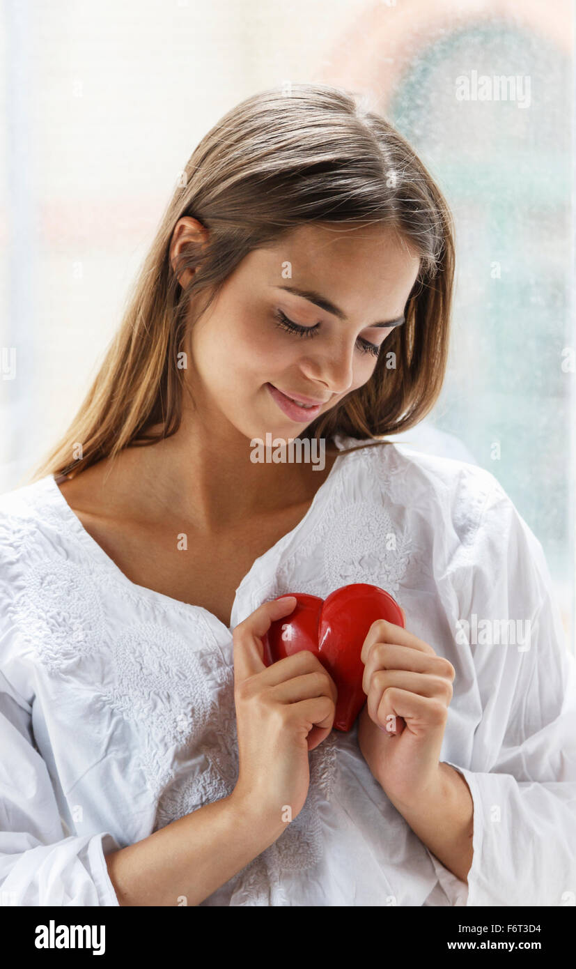 Caucasian woman holding heart Stock Photo Alamy