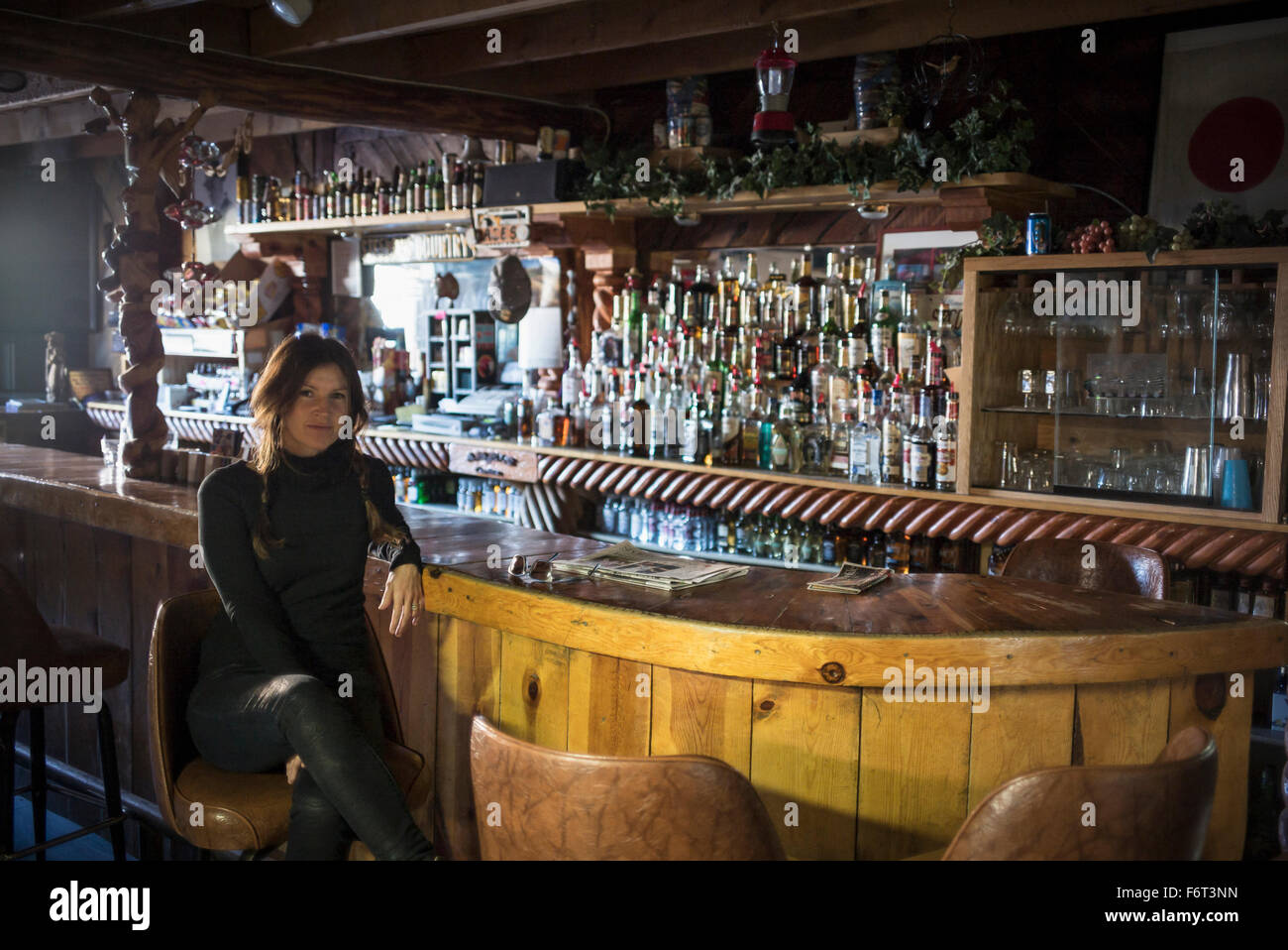 Caucasian woman sitting in empty bar Stock Photo