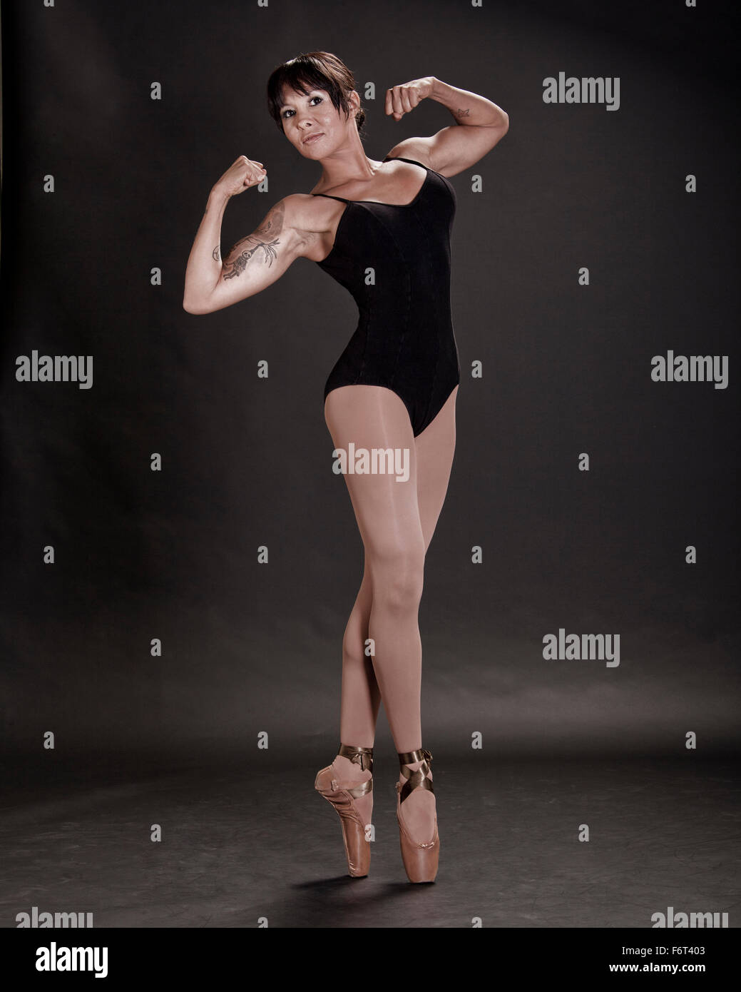 Hispanic ballet dancer flexing muscles Stock Photo
