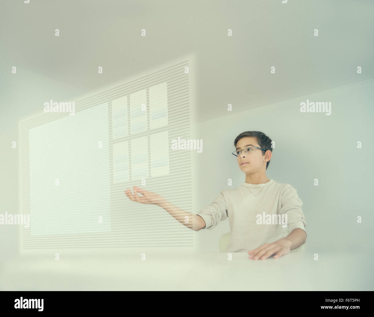 Mixed race boy using holographic screen Stock Photo