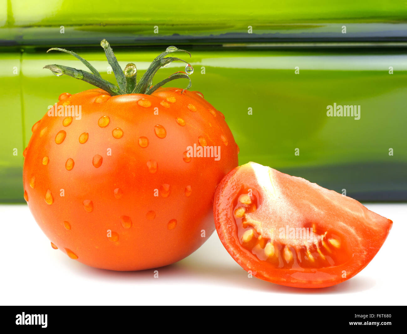 Tomato whole tomato slice water drops Stock Photo