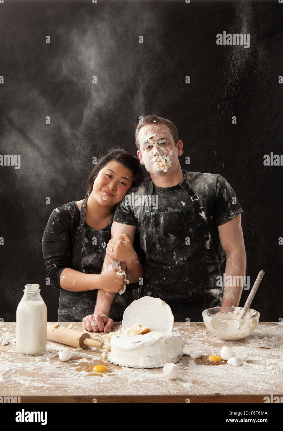 Messy couple hugging and baking Stock Photo