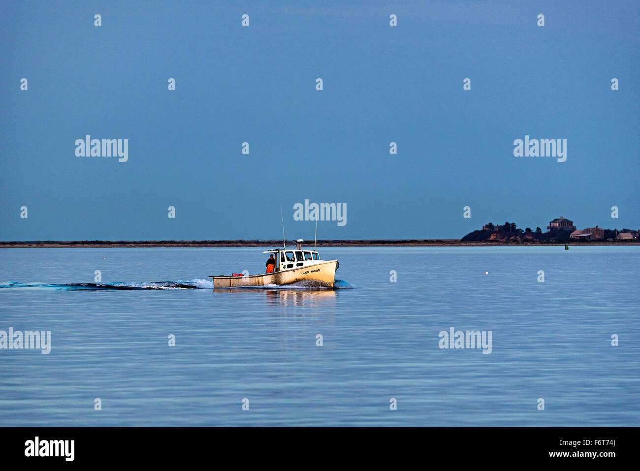 Lobster fishing boat returns from checking traps. Stock Photo
