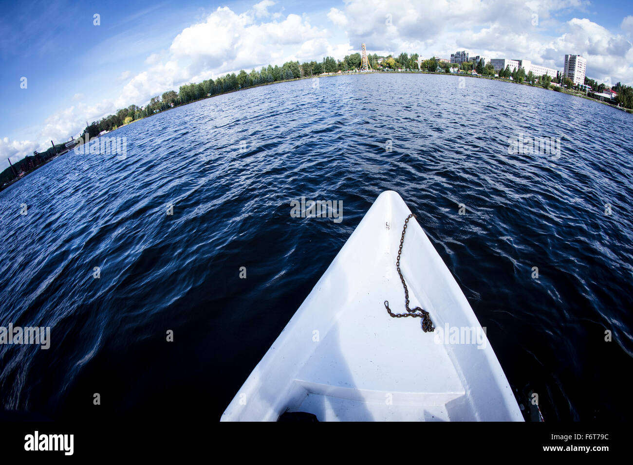 Rowboat floating in lake Stock Photo