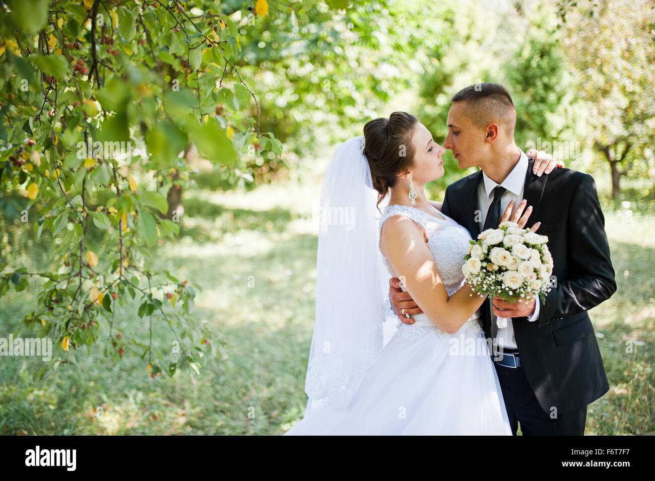 young happy wedding couple on the green park Stock Photo - Alamy
