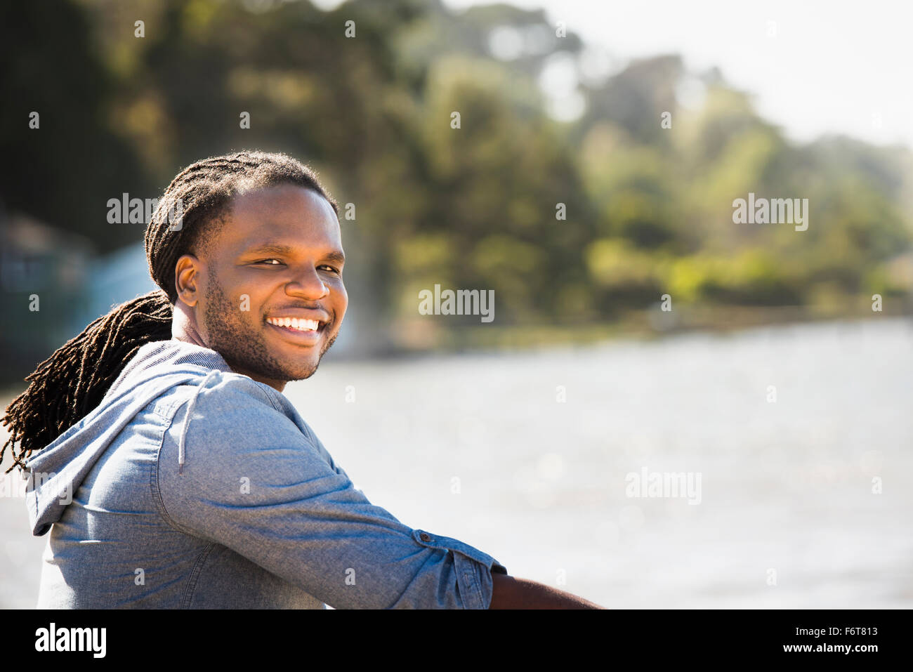 African American man smiling outdoors Stock Photo