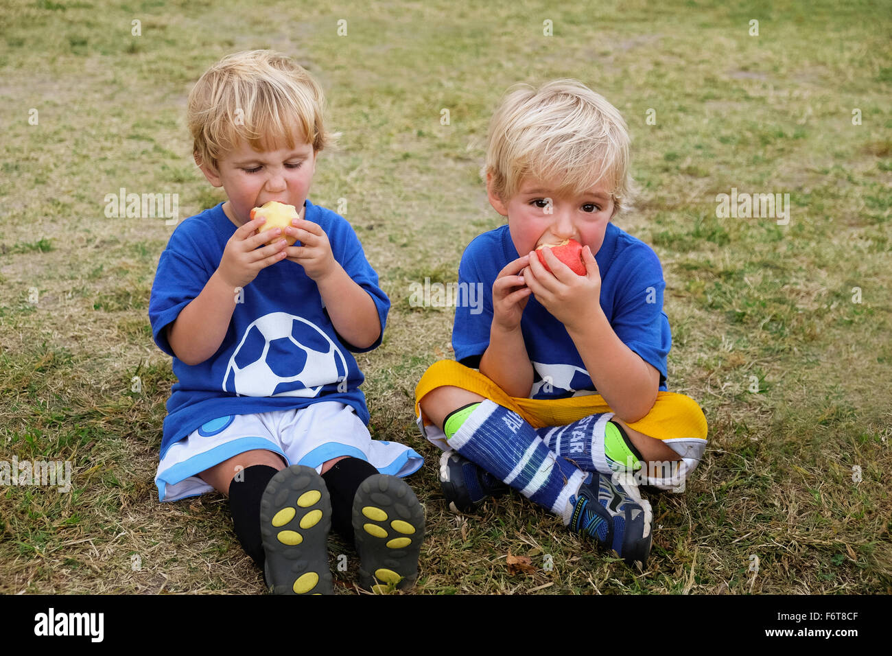 Caucasian soccer players eating apples Stock Photo