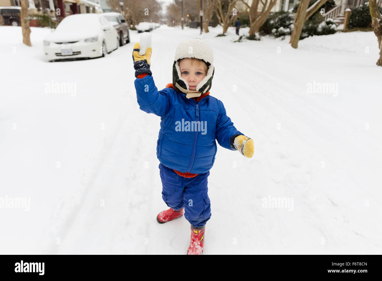 Caucasian boy throwing snowball Stock Photo