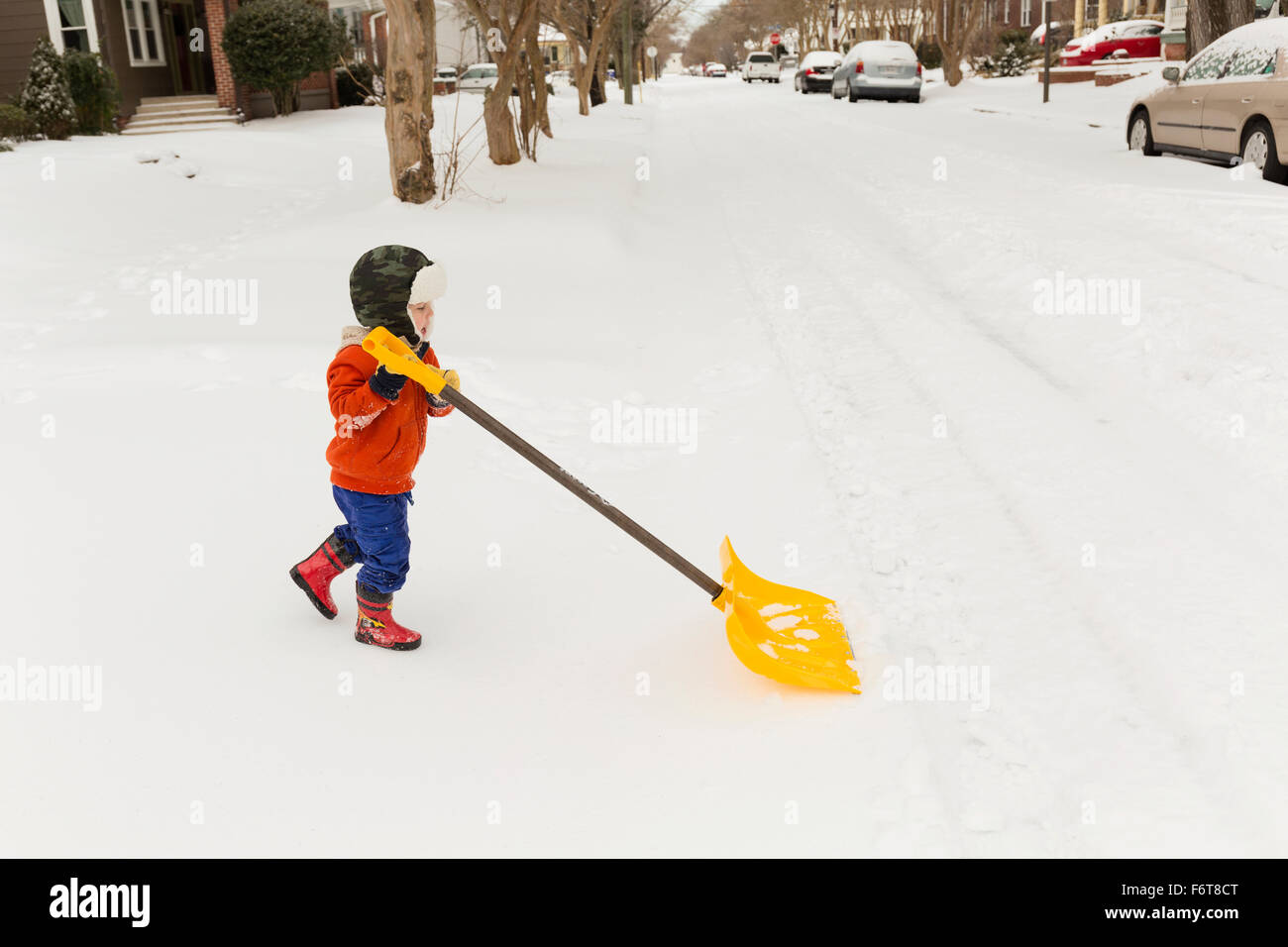 Caucasian boy shoveling snow Stock Photo