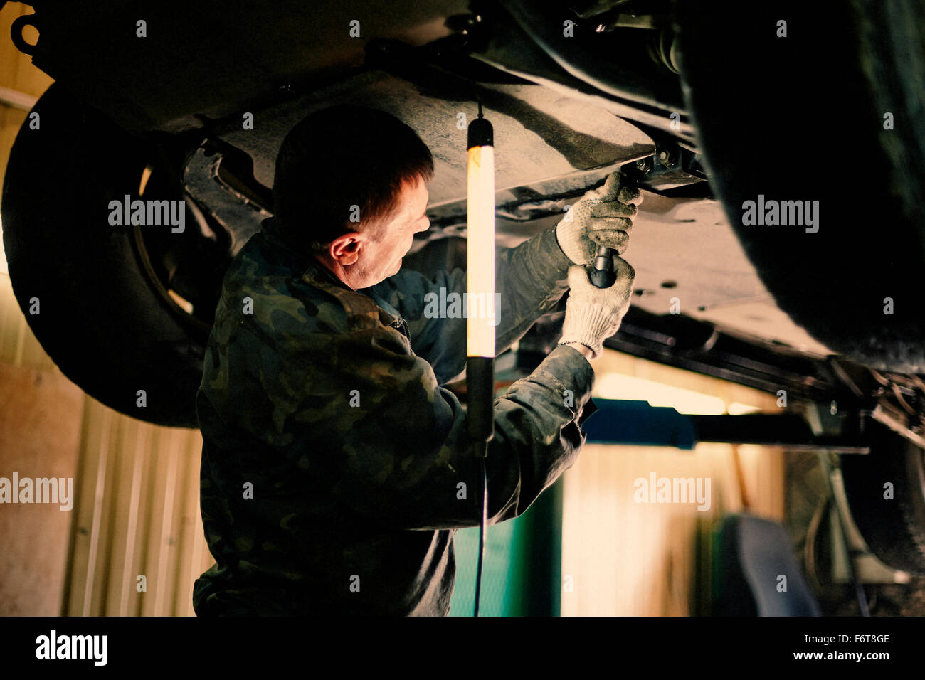 Caucasian mechanic fixing car Stock Photo