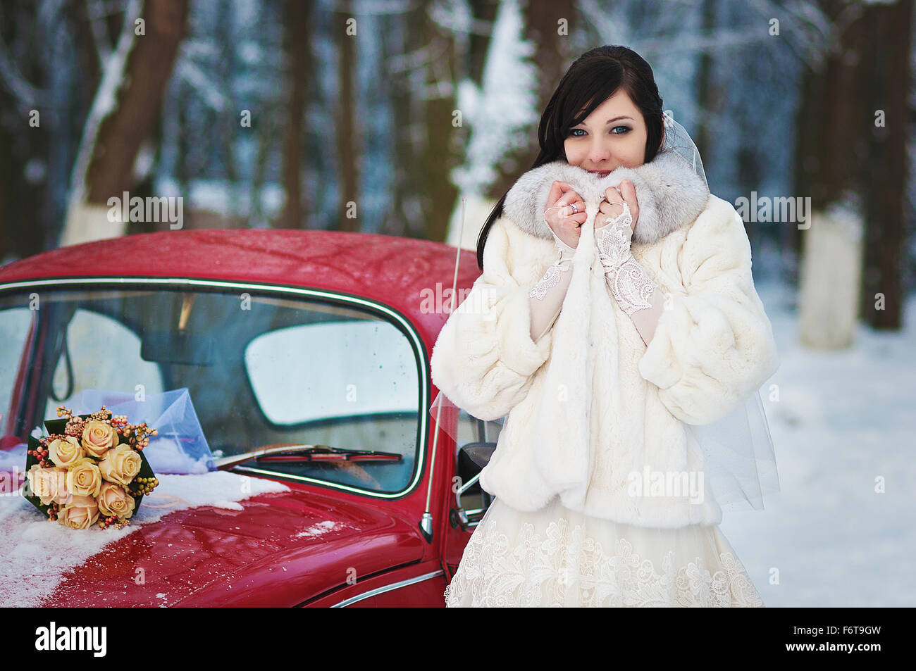 Bride in winter near old vintage car Stock Photo - Alamy