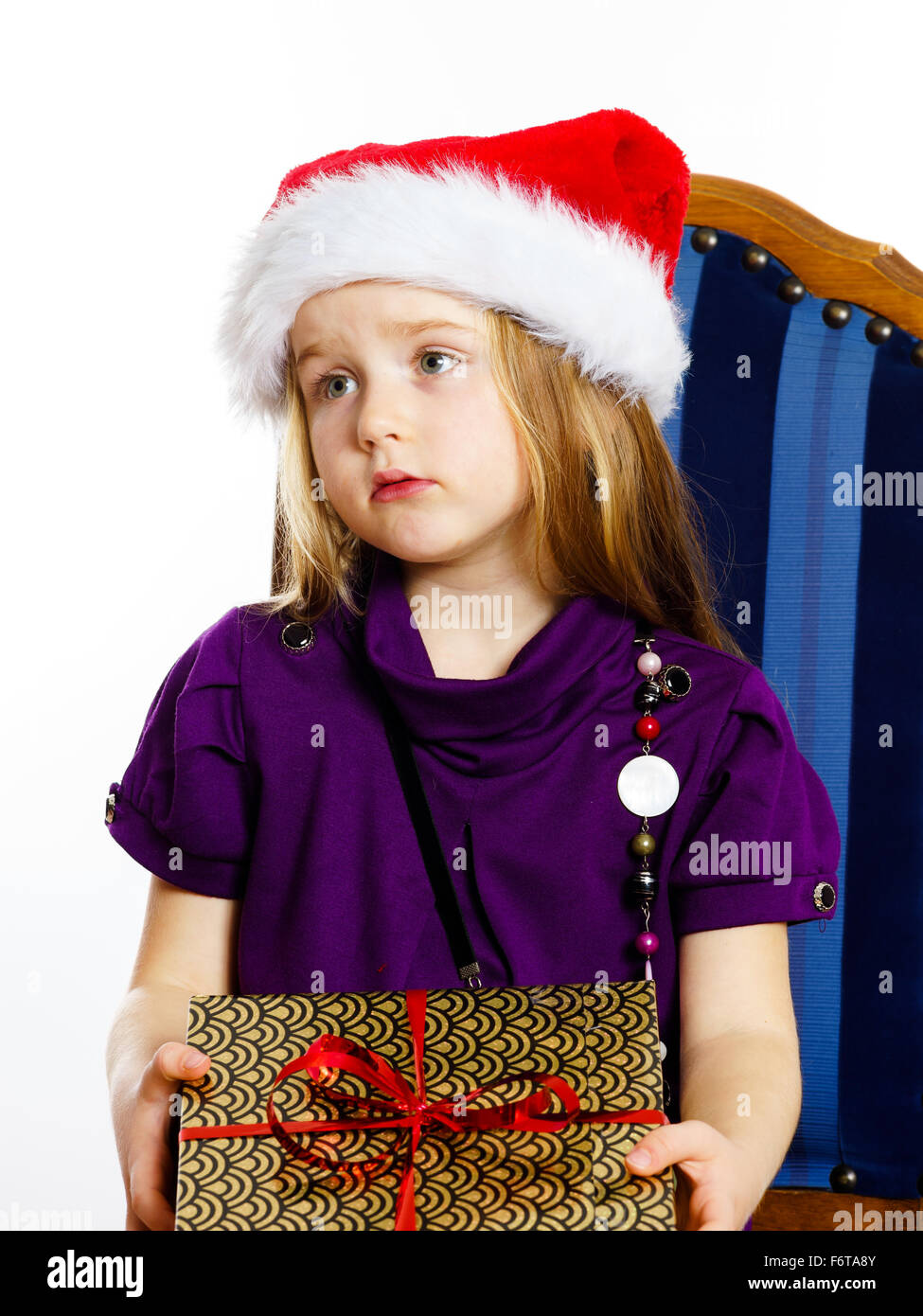 Cute little preschooler girl in red santa hat with gift box isolated on ...