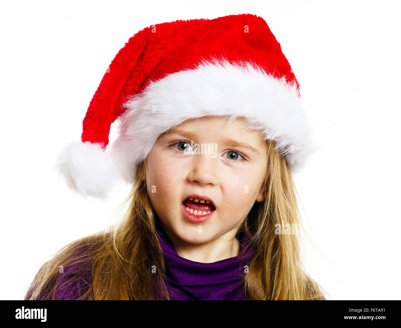 Cute little preschooler girl in red santa hat with gift box isolated on ...