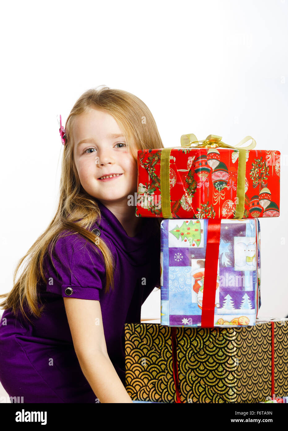 Cute little preschooler girl in red santa hat with gift box isolated on ...